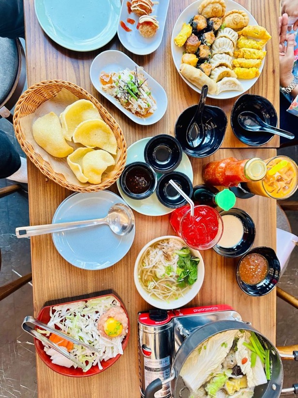 A table covered in dumplings, buns and small dishes